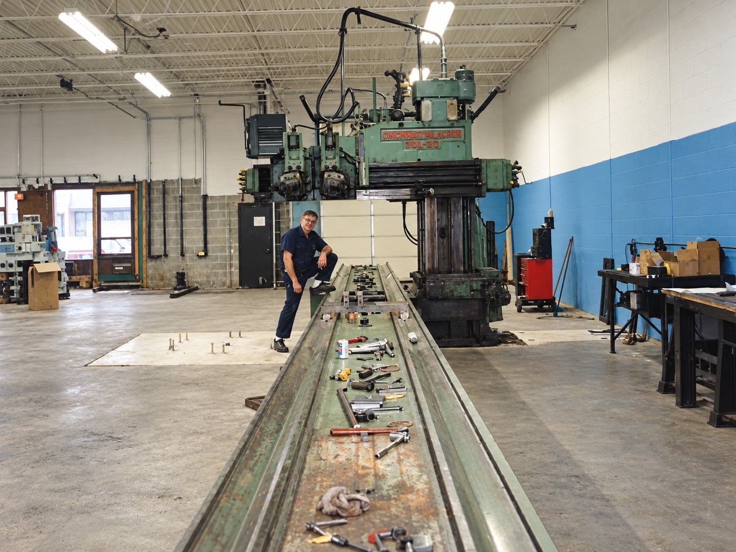 Inside the Power Brake Dies shop, a worker and a long Cincinnati Milacron tooling bed